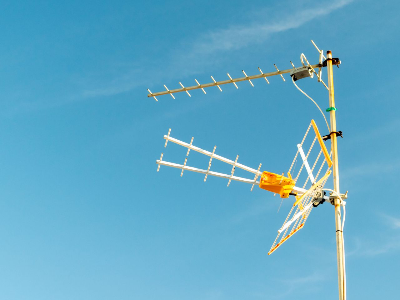 low angle shot television antenna captured sunny day with clear sky